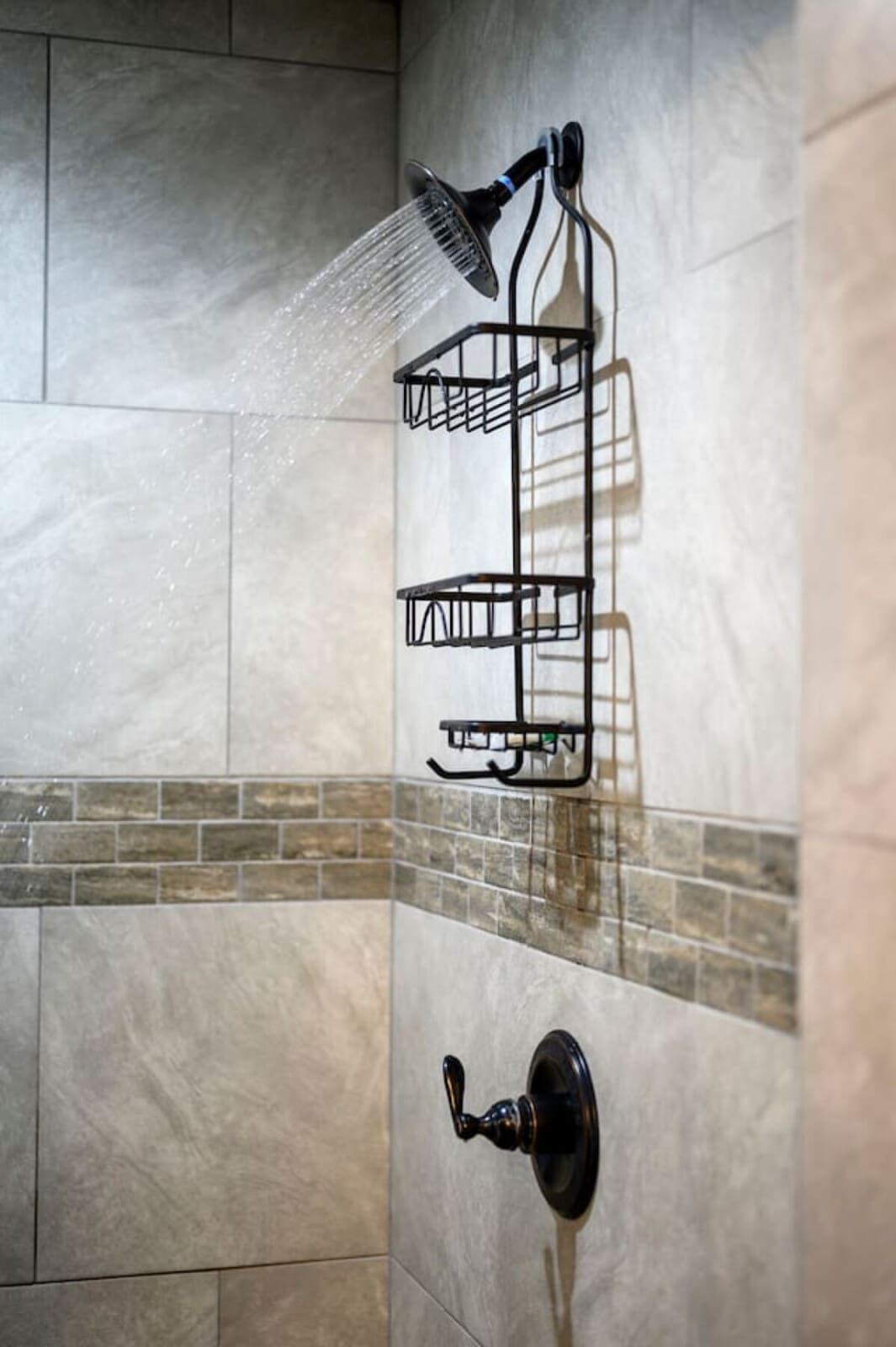 Check out this gorgeous rainfall showerhead with built-in storage shelves in the spa-like master bath.