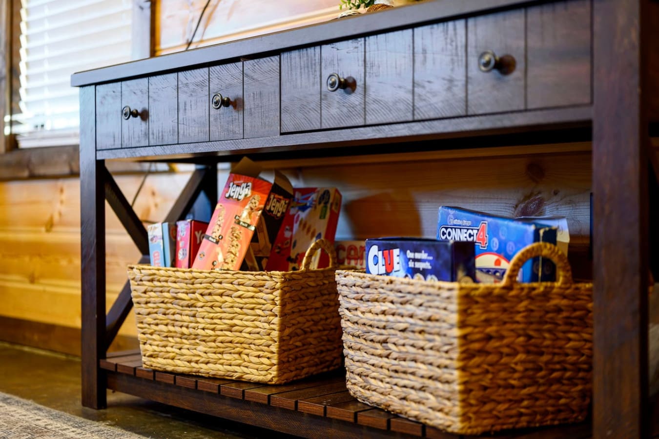 The spacious entertainment console features plenty of storage with woven baskets and charming vintage-style drawers.