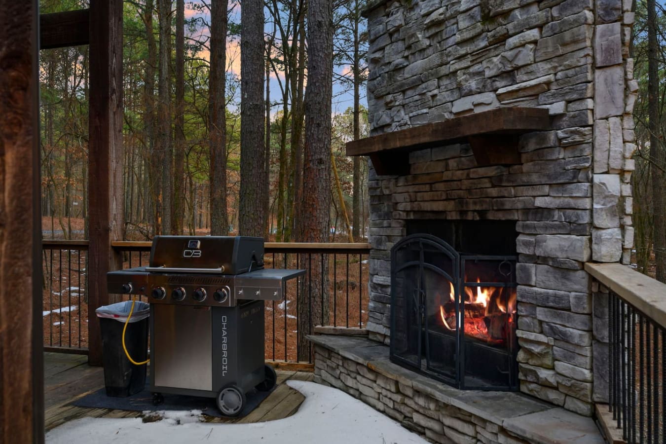 This gorgeous deck has both a wood-burning fireplace and gas grill nestled in the forest for the ultimate outdoor entertaining.