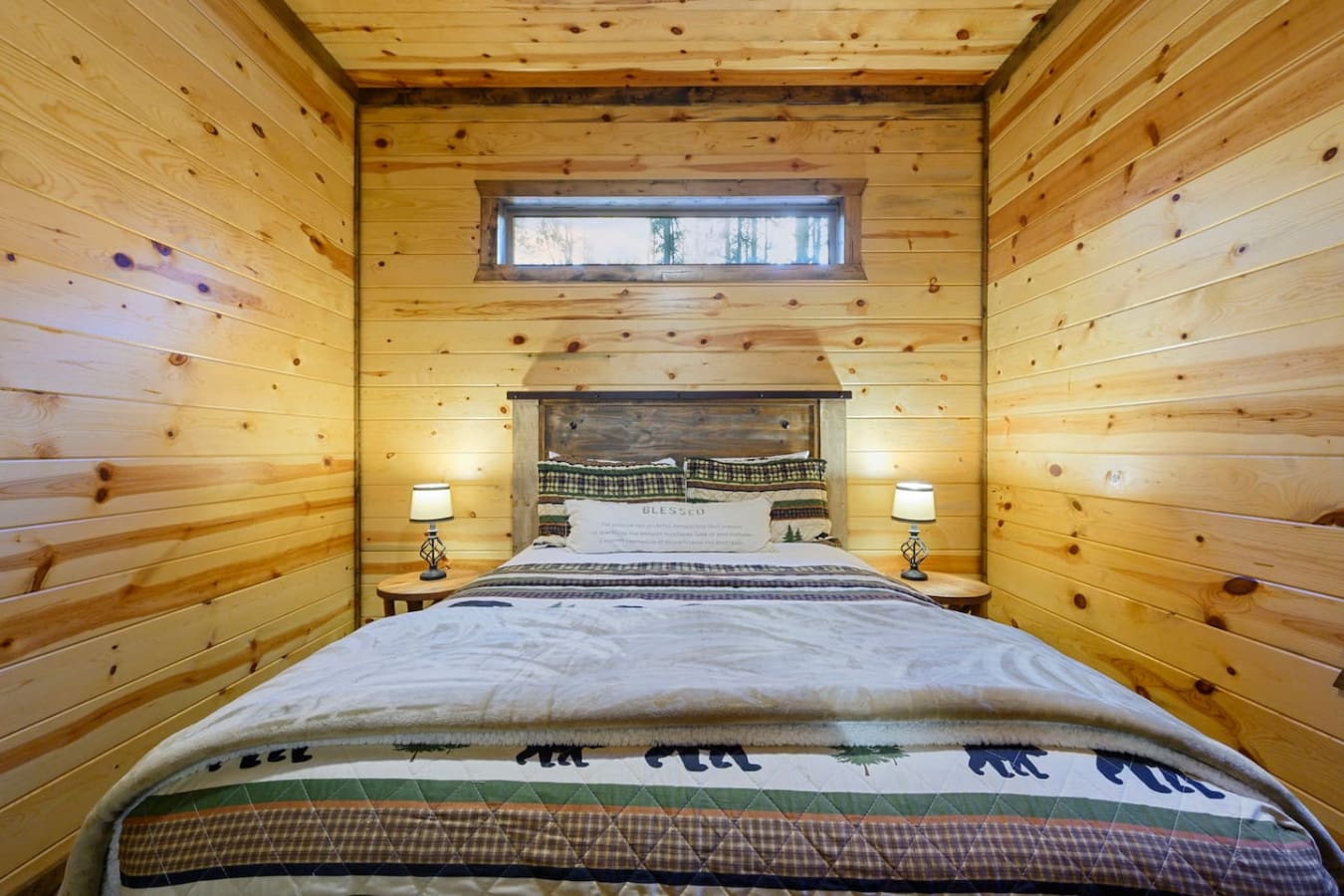 This cozy log cabin bedroom has everything you need for a peaceful mountain getaway with that authentic rustic charm.