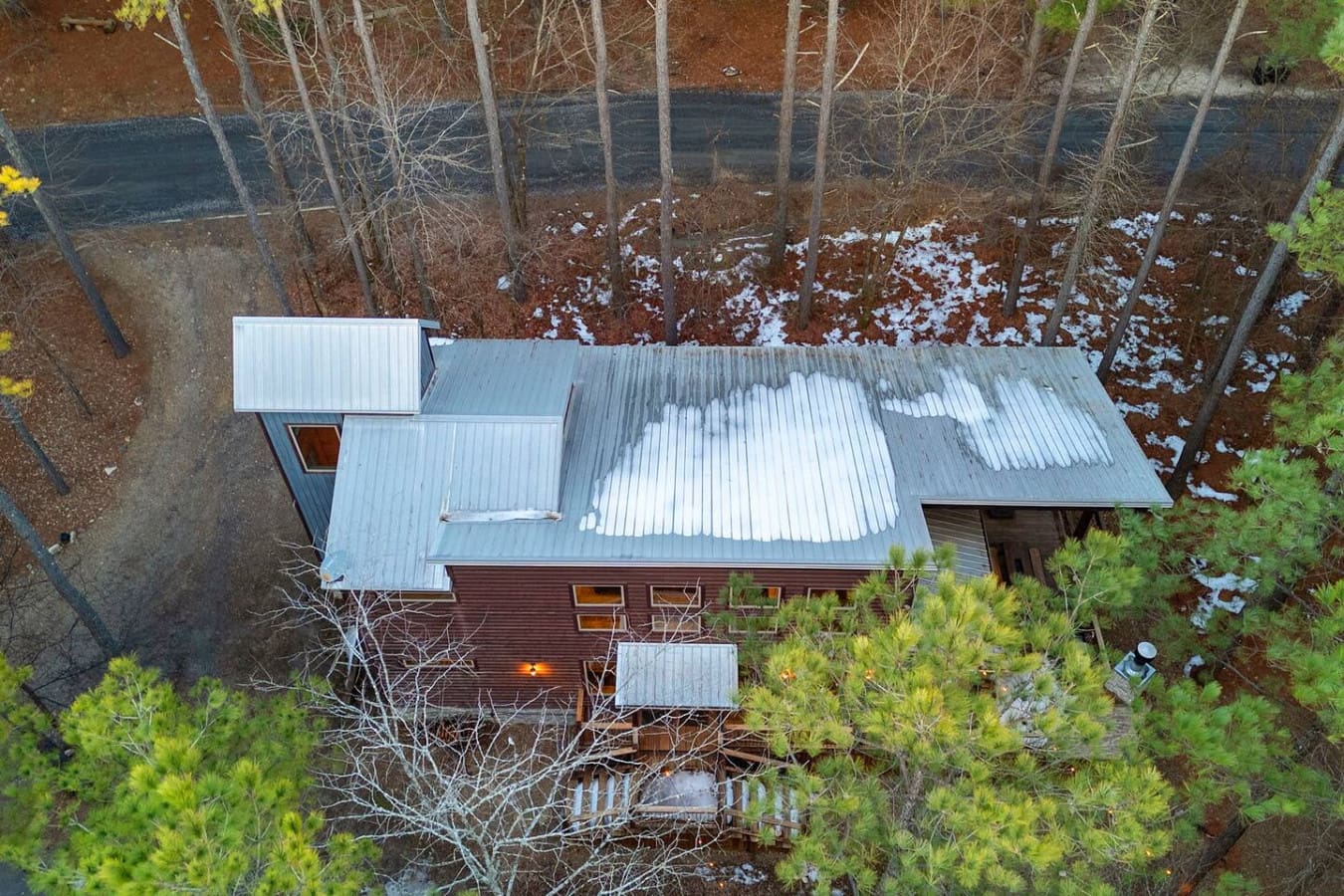 Stunning waterfront cabin nestled in the woods with metal roof and direct lake access right outside your door.