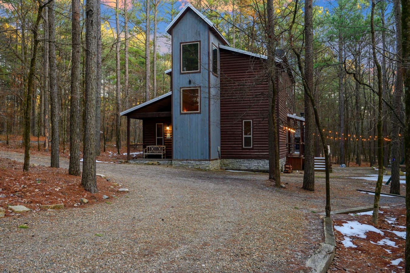 This stunning modern cabin nestled in the woods offers the perfect cozy retreat surrounded by tall trees and natural beauty.