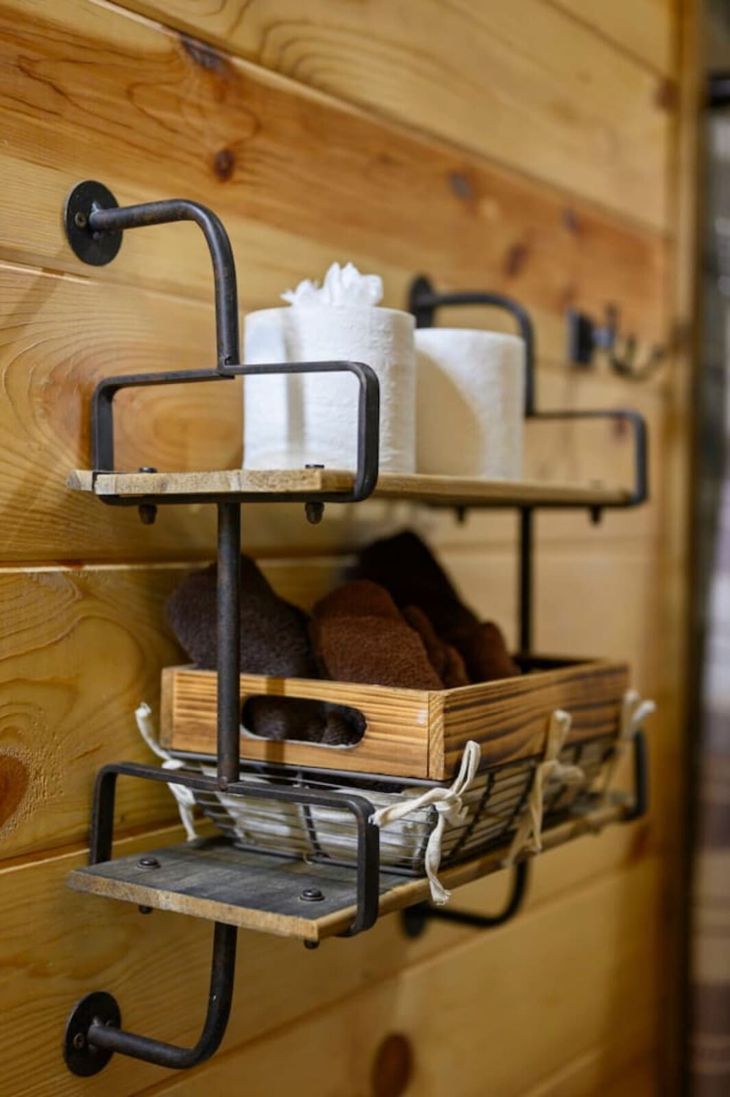 Industrial-style wall shelving adds rustic charm and practical storage throughout the cabin.