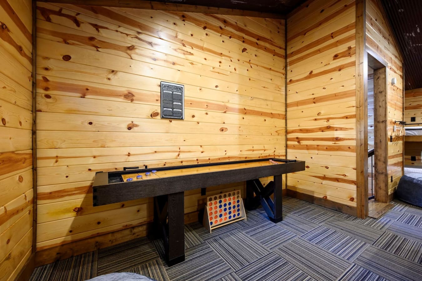 Game room with shuffleboard and Connect Four for some friendly competition with the family.