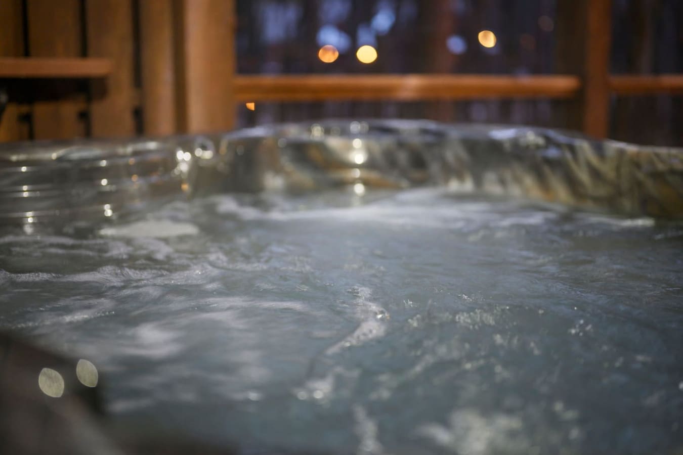 Soak in the hot tub while gazing out at the city lights twinkling in the evening darkness.