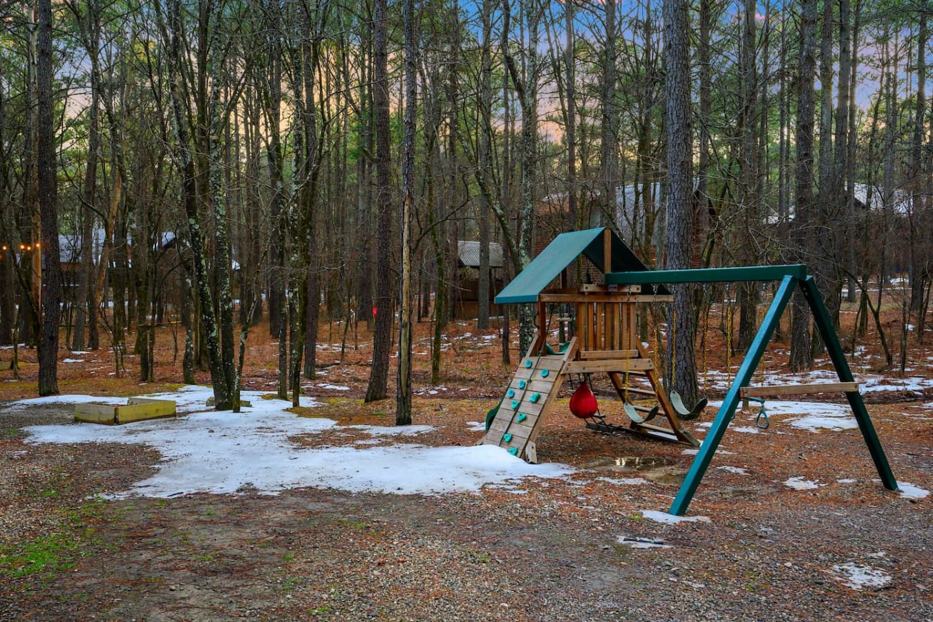 The property sits on beautiful wooded grounds with a playground area perfect for keeping the kids entertained.