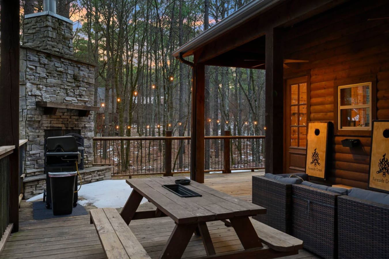 This stunning deck has everything—a stone fireplace, hot tub, grill, and views into the peaceful woods.