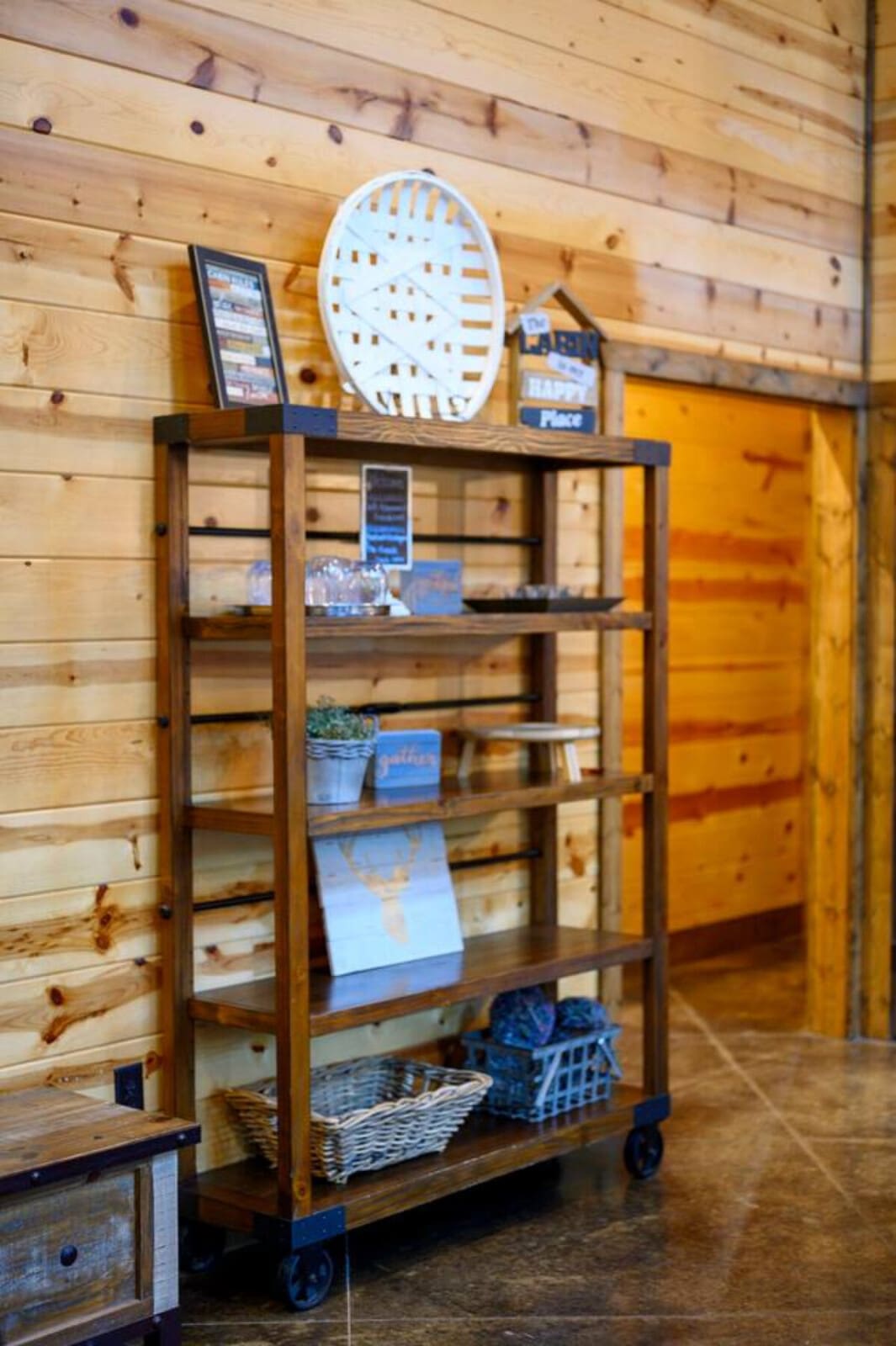 Cozy wooden cabin interior with organized shelving and rustic charm throughout the space.