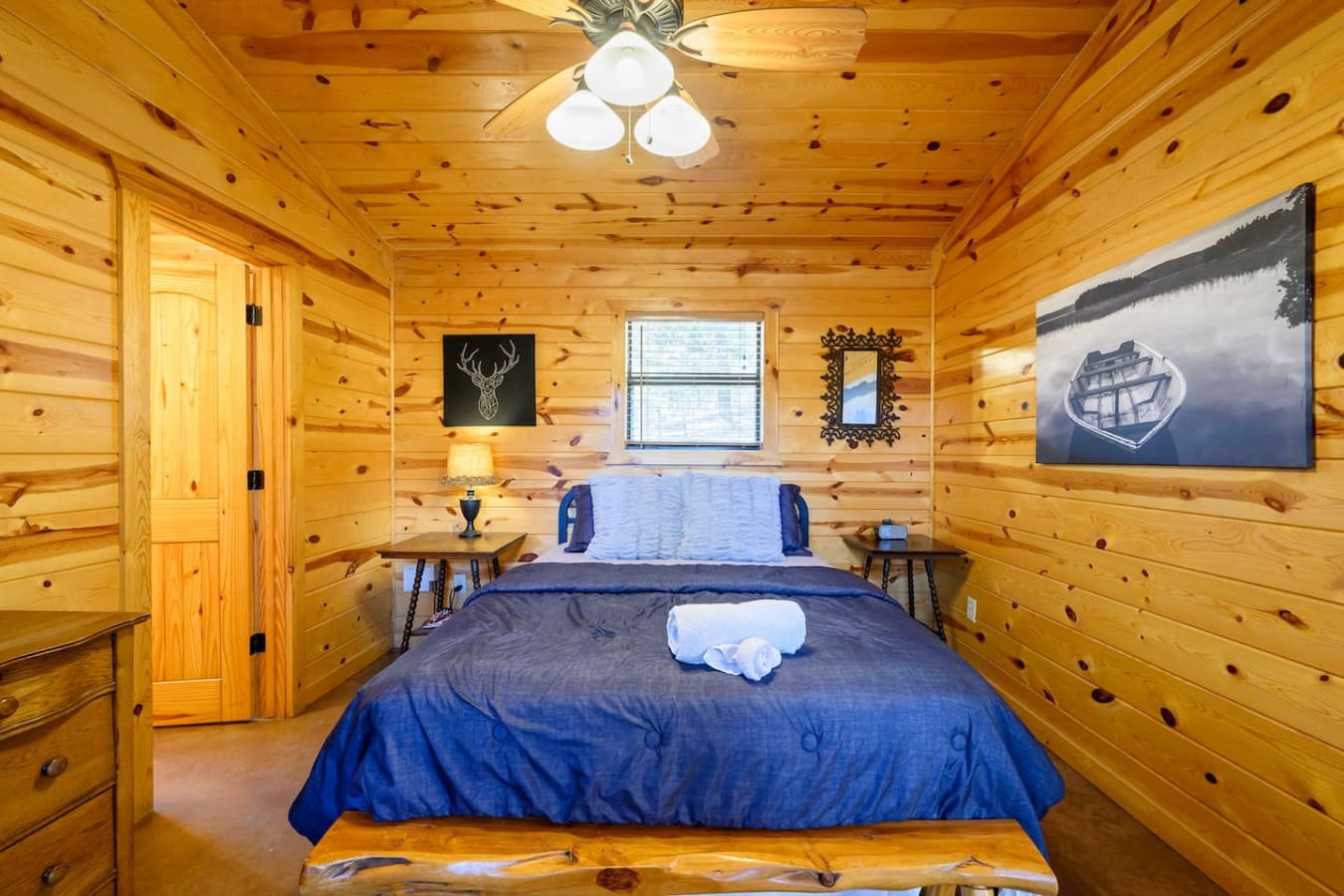 This cozy log cabin bedroom features a comfy king bed, warm wood throughout, and all the rustic charm you need for a relaxing getaway.
