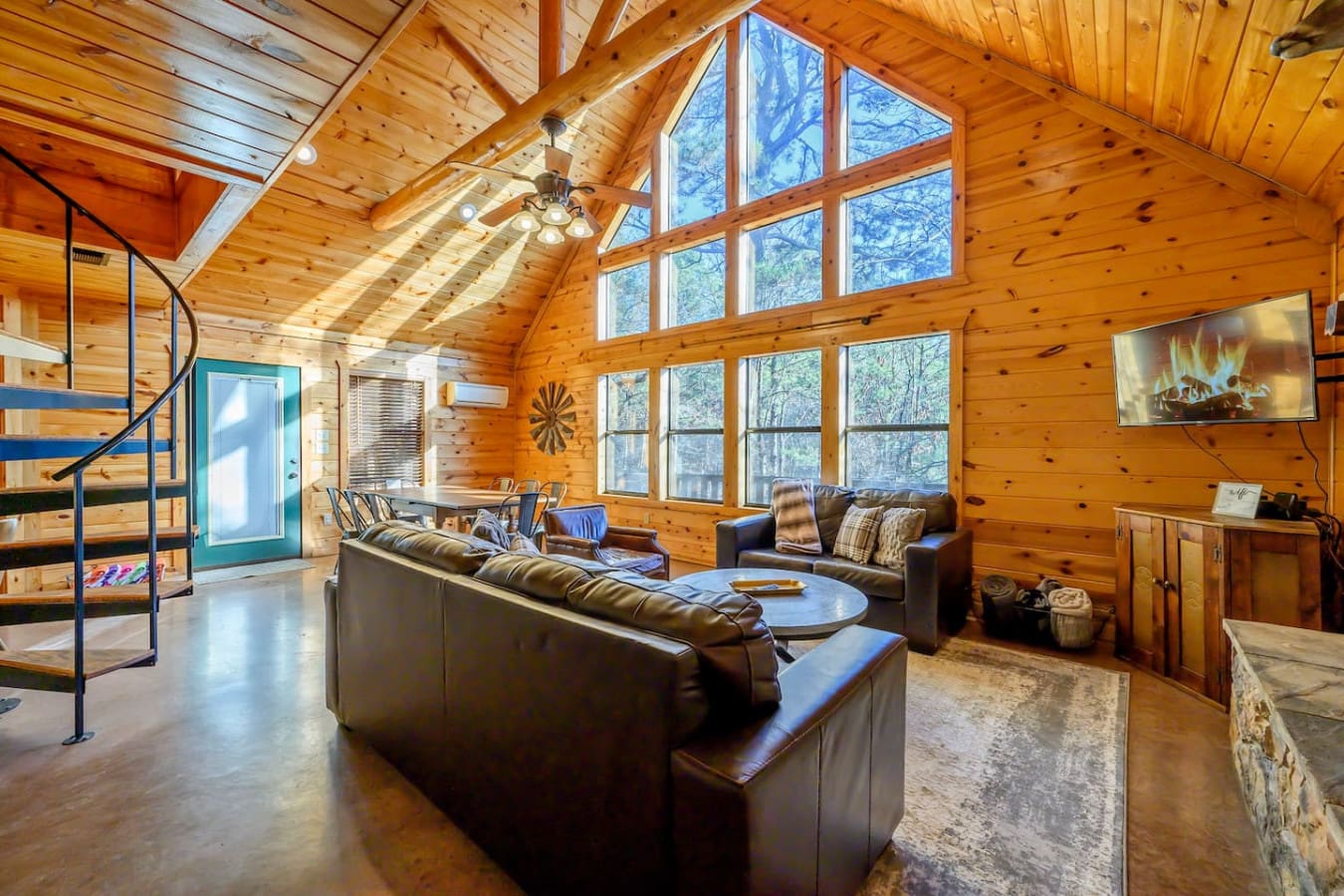 This open-concept cabin has soaring ceilings, tons of natural light, and views of the woods from every angle.