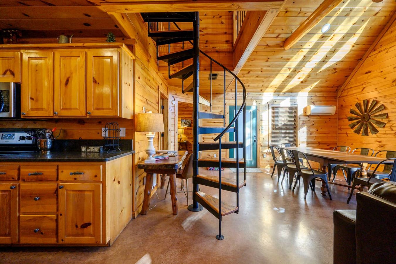 This open-concept cabin flows beautifully with exposed wood beams, a spiral staircase, and tons of natural light throughout.