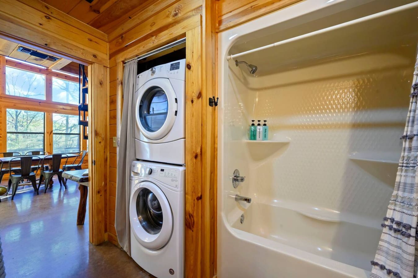 This luxury laundry room features stacked washer/dryer units and a full bathroom with shower, perfect for extended stays.