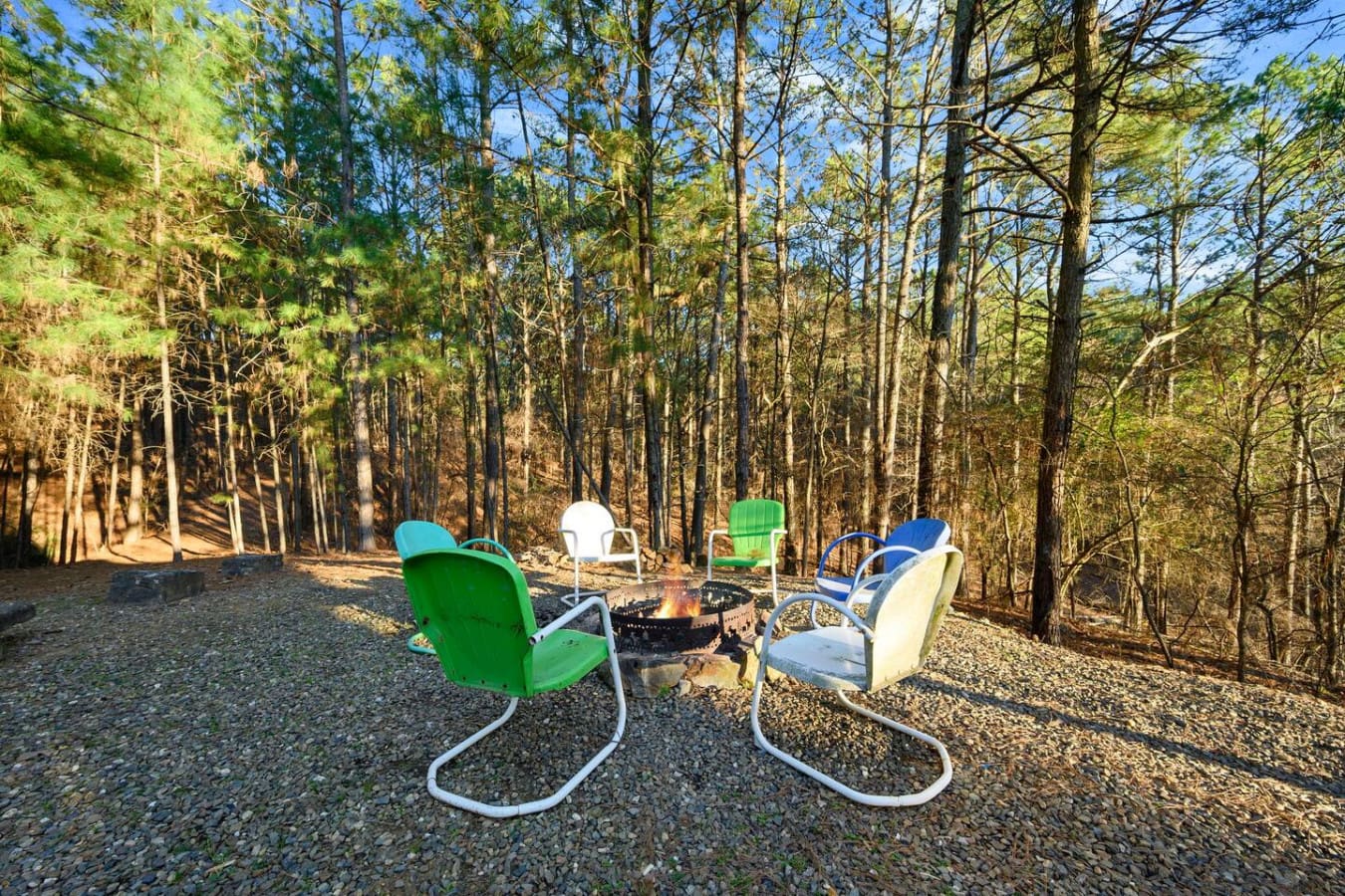 Nothing beats gathering around the fire pit with these retro chairs surrounded by towering pines.