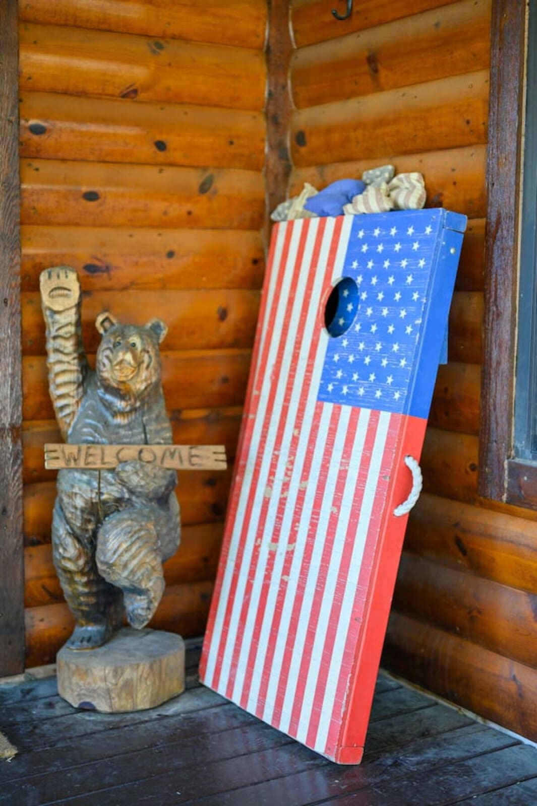 Cozy log cabin interior with rustic wood beams and charming Americana decor details.
