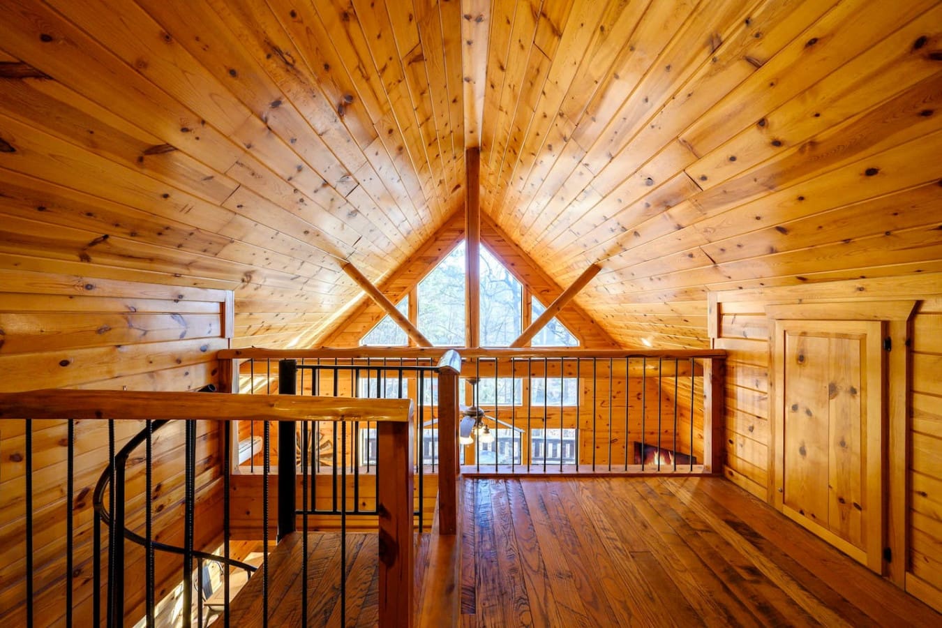 Soaring vaulted ceilings and natural light flood this stunning loft bedroom with unbeatable character.