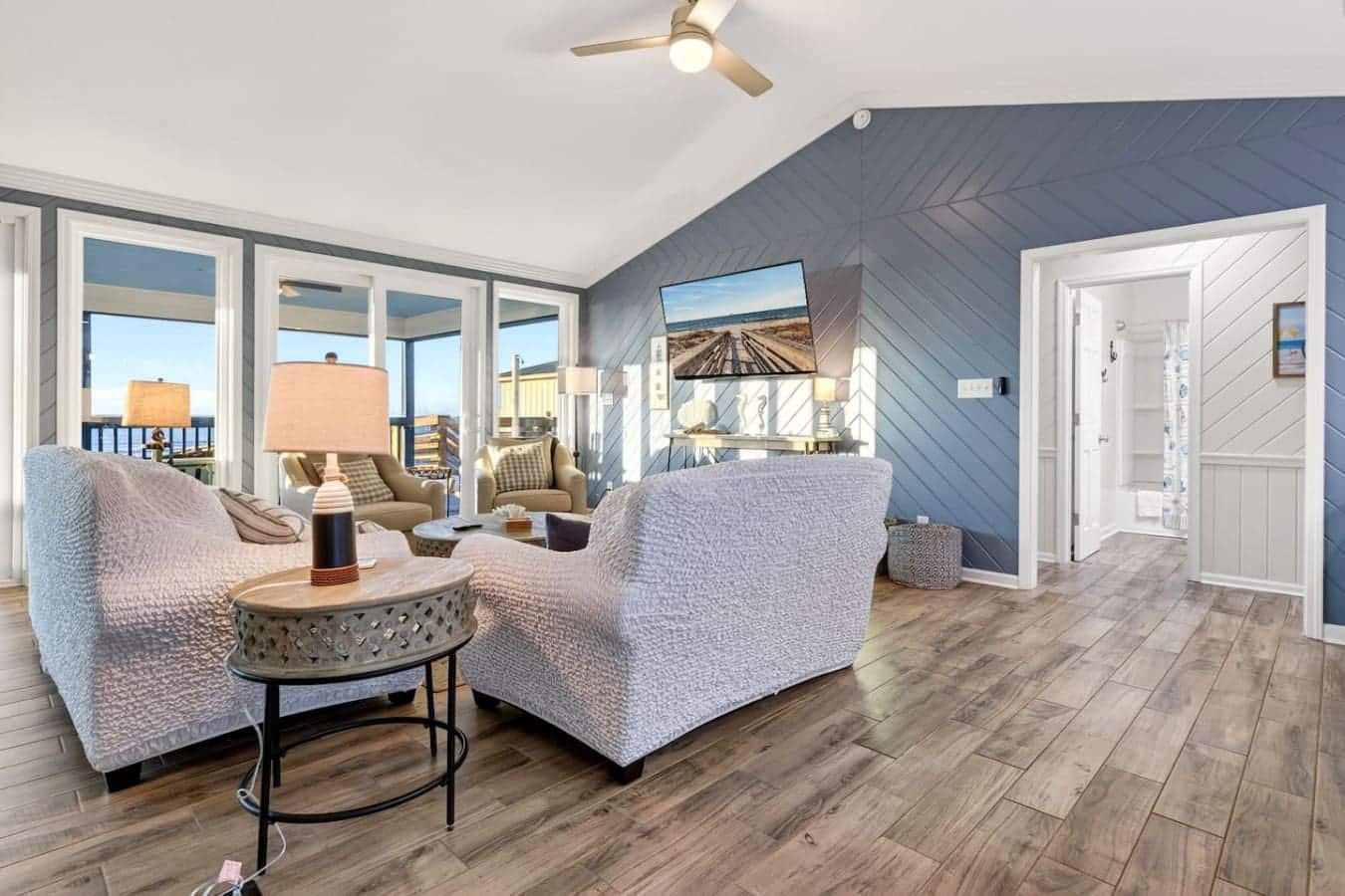 This spacious master suite features stunning views, a cozy seating area, and direct access to a private balcony overlooking the countryside.
