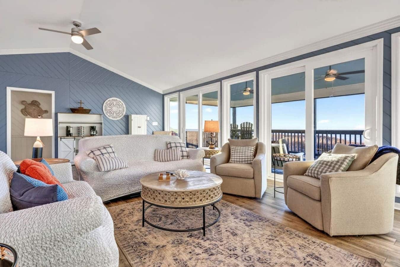 This oceanfront living room is basically designed for lounging with those huge windows and killer water views.