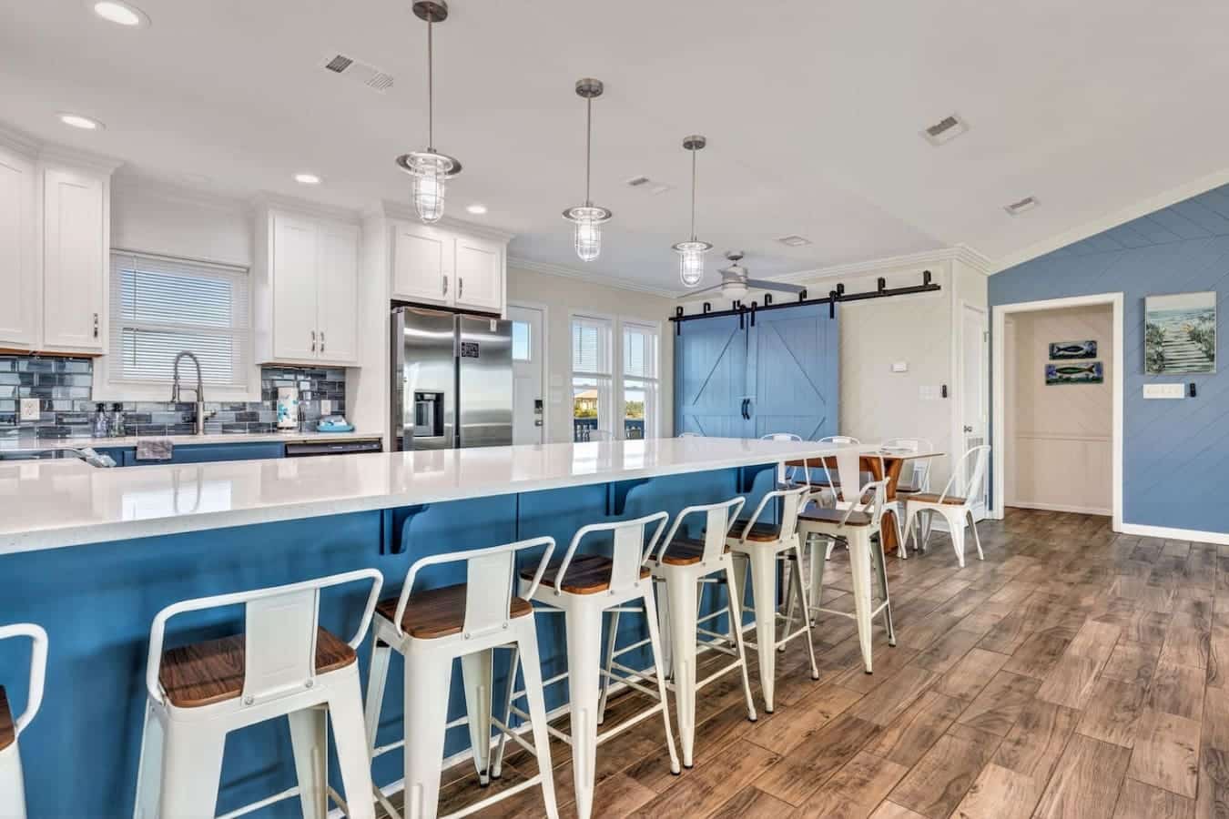This stunning kitchen and dining space features premium stainless steel appliances, a spacious island, and plenty of room for the whole crew.