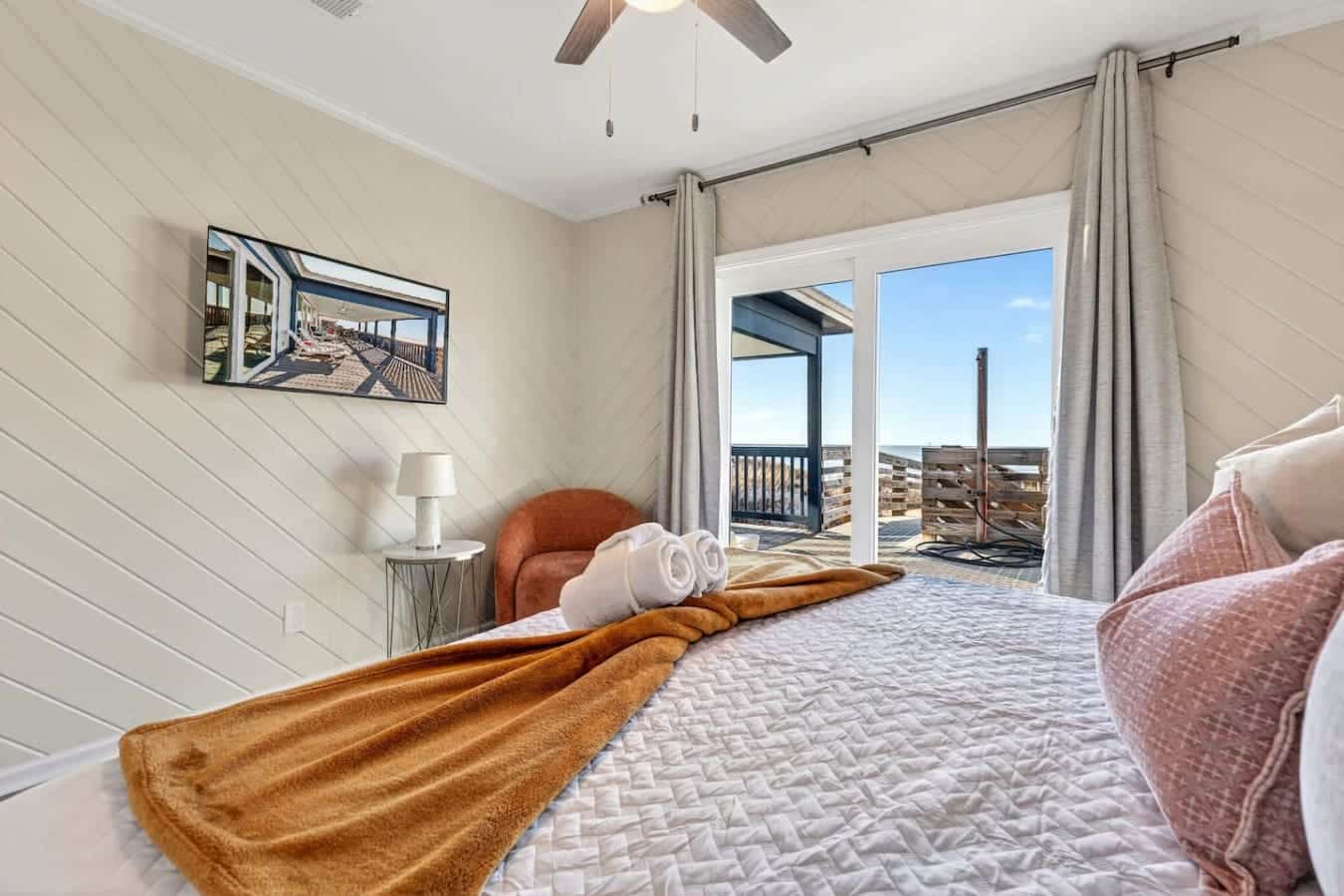 Wake up to panoramic ocean views from this stunning beachfront bedroom with direct deck access.
