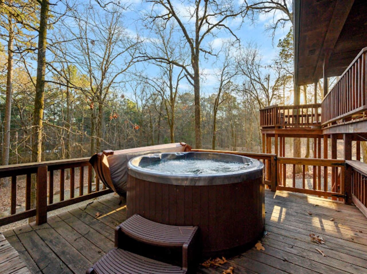 Soak in your private hot tub while surrounded by peaceful forest views from this spacious deck.