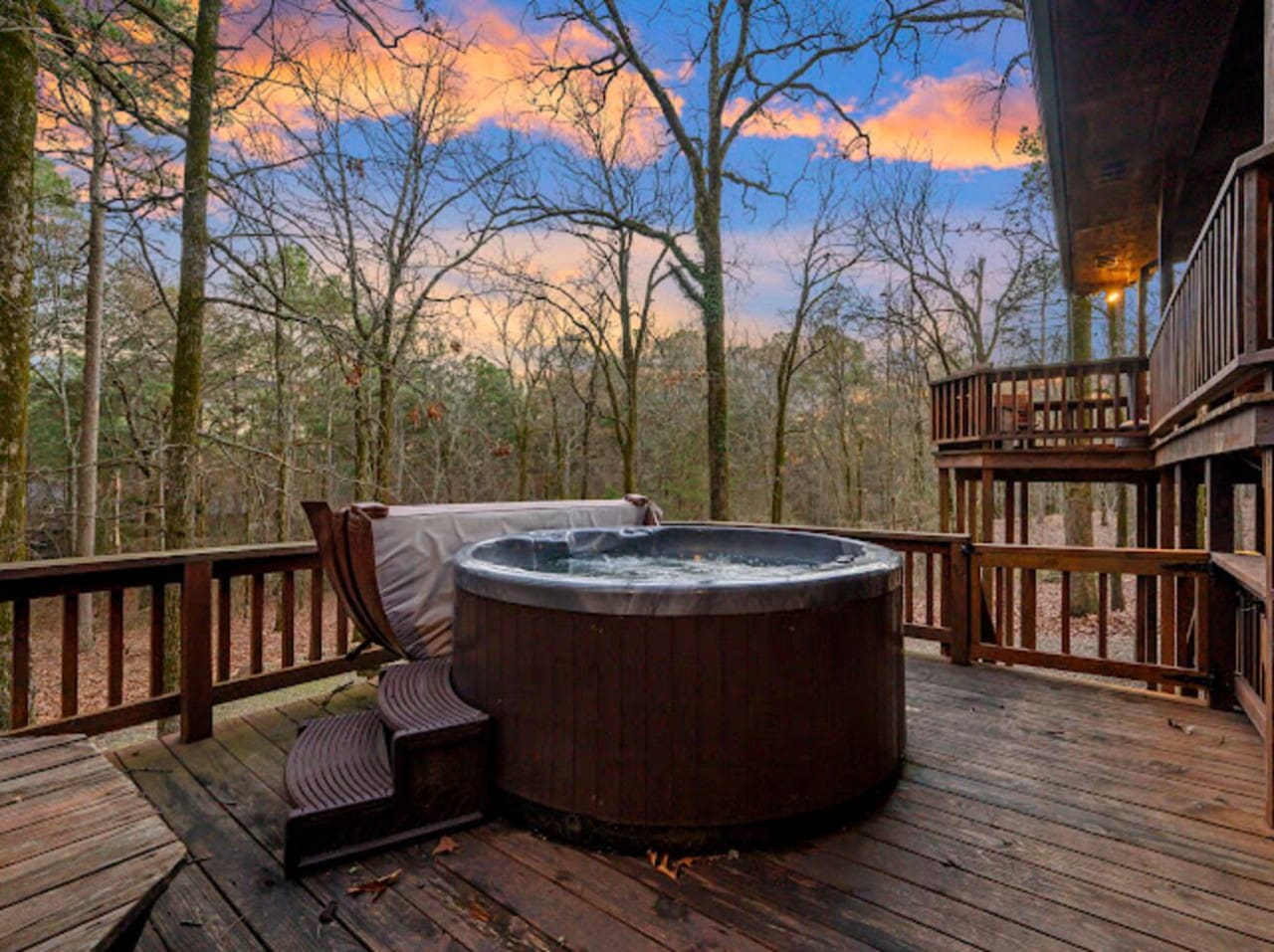 Soak in your private hot tub while watching the sunset paint the sky over endless forest views.