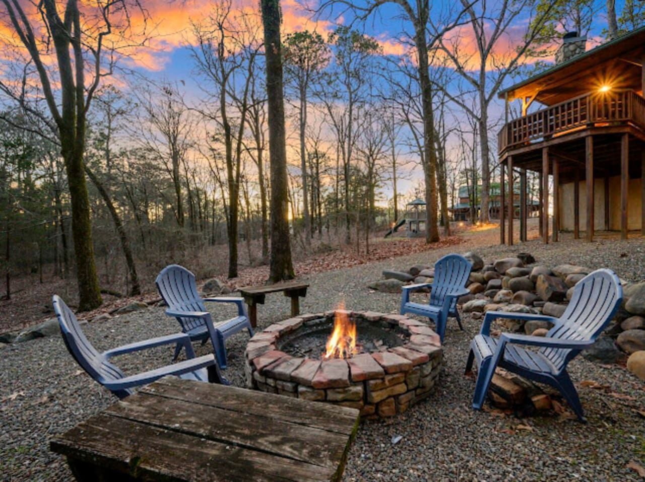 Gather around the fire pit with Adirondack chairs and watch the sunset through the trees from your private wooded retreat.