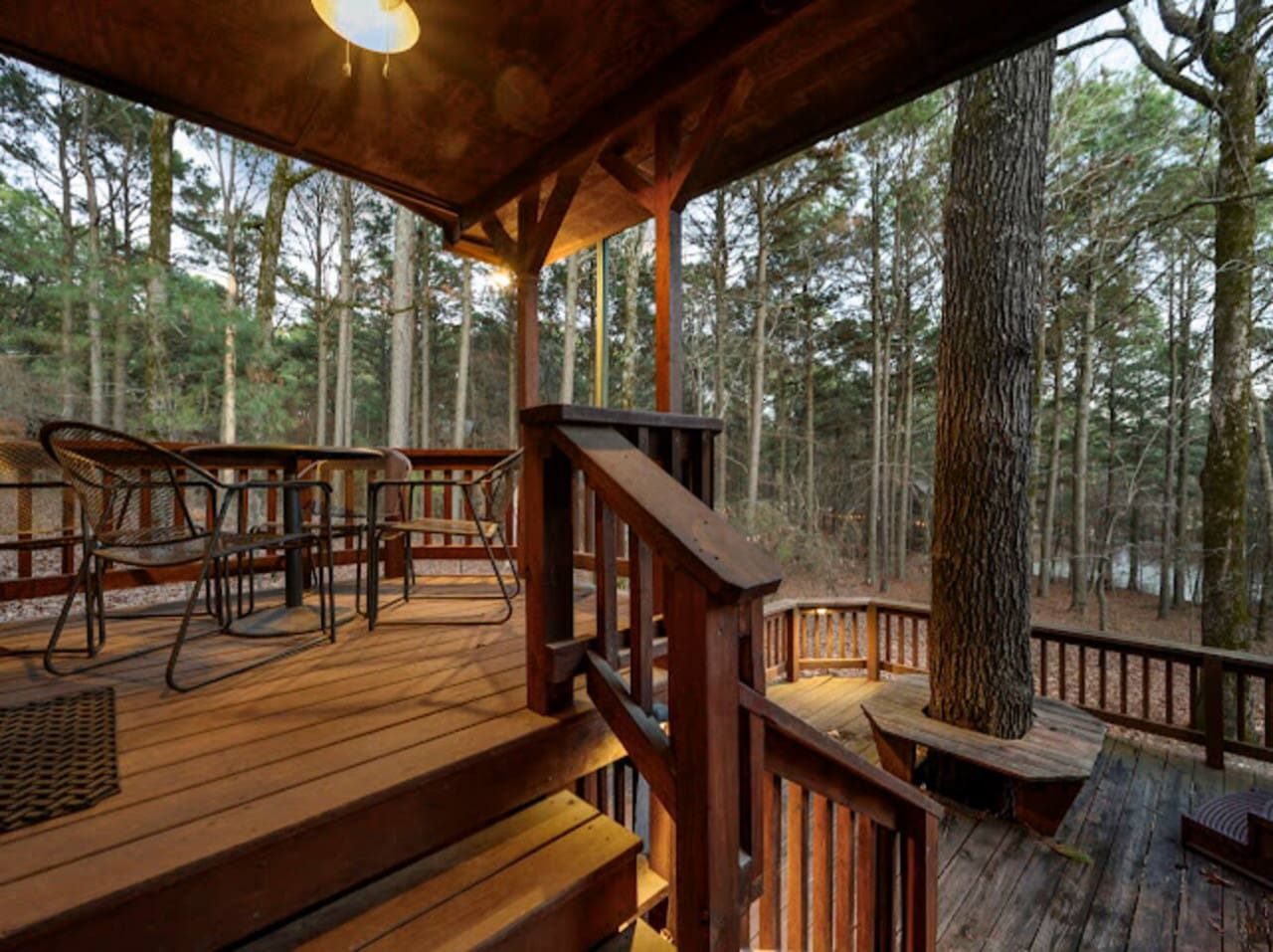 This multi-level covered deck is basically your own treehouse with all the comforts, surrounded by towering pines.