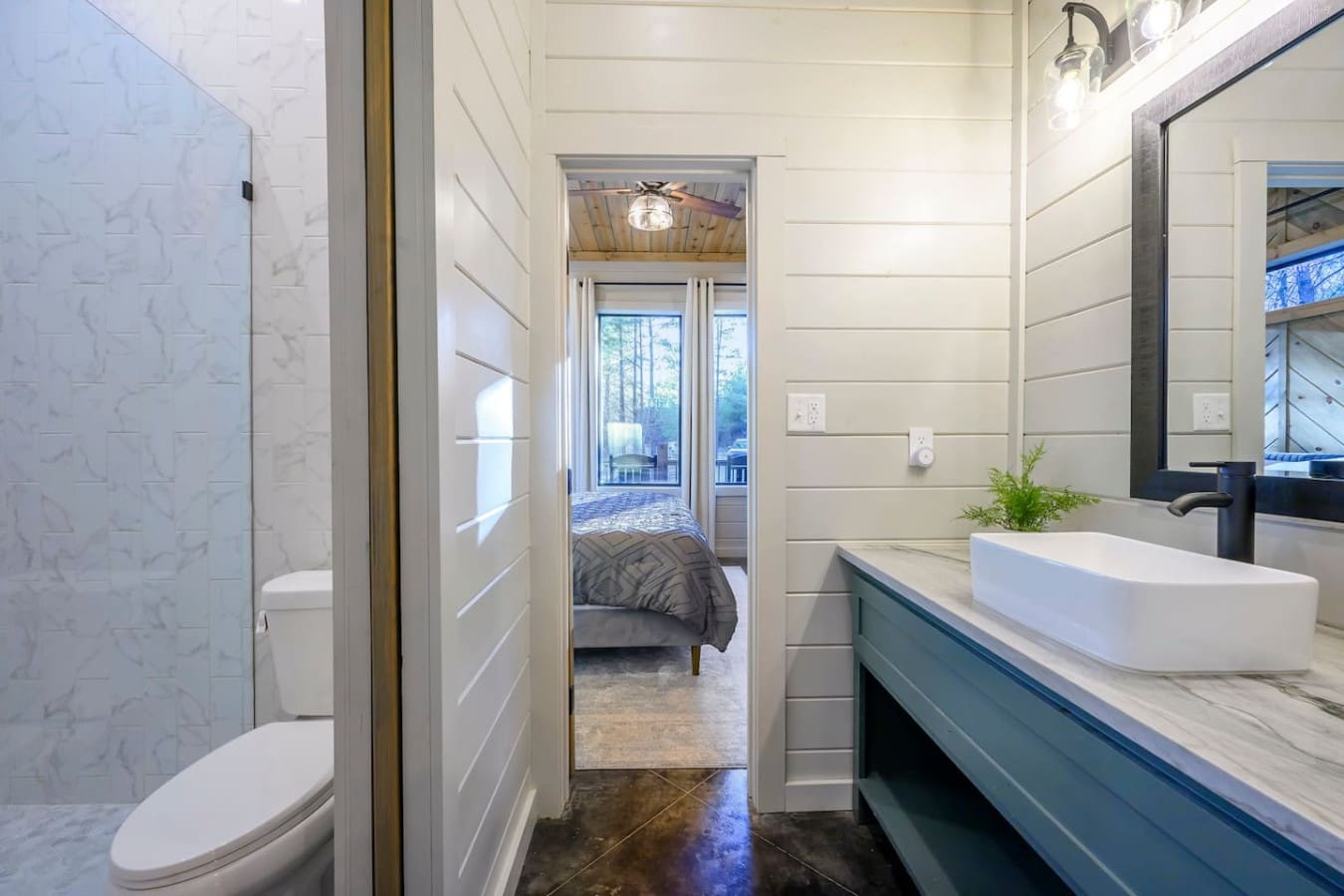 This spa-like master bath flows straight into the bedroom with that incredible view out to the deck.