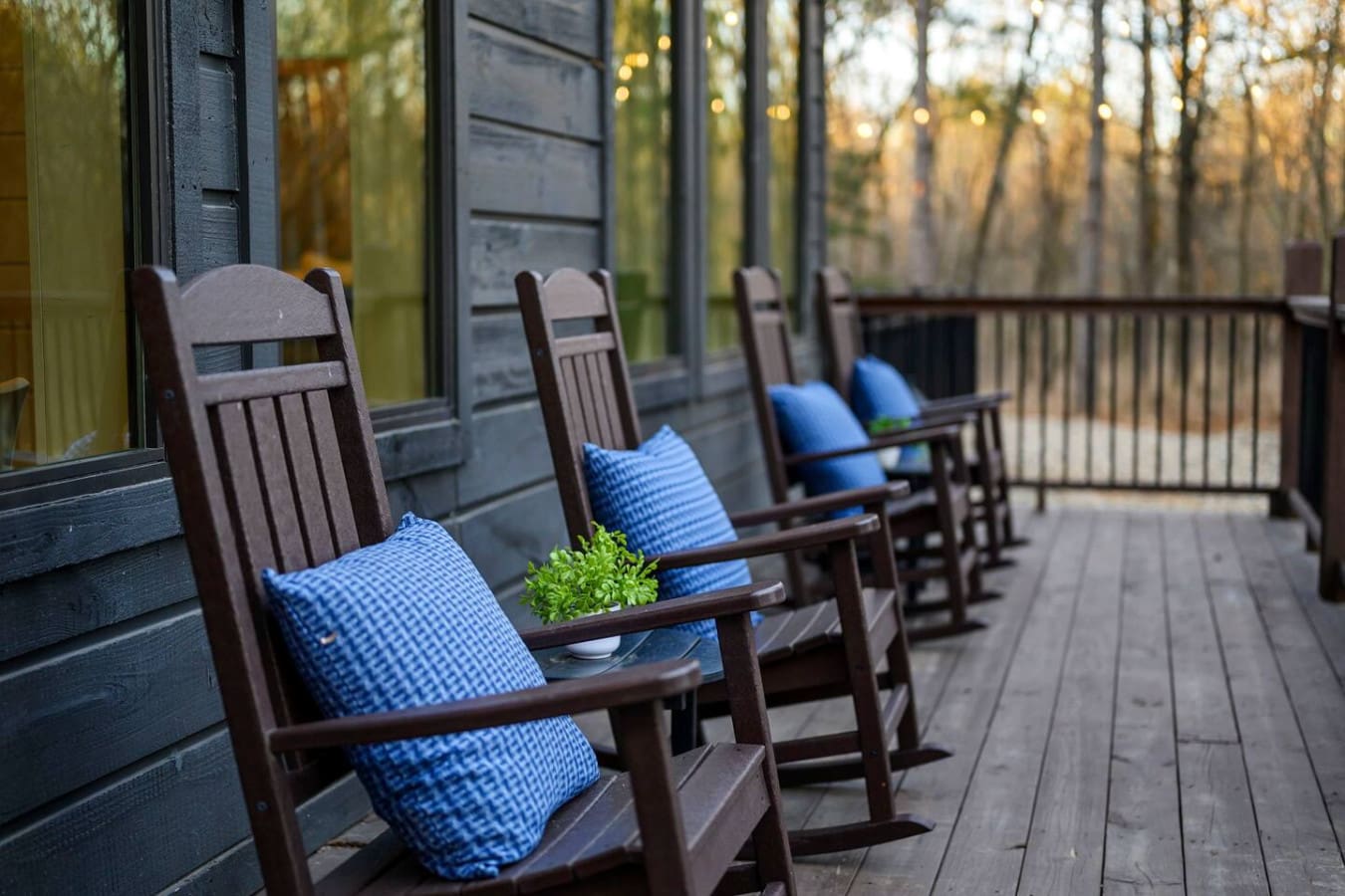 Cozy covered porch with rocking chairs overlooking the forest—perfect for morning coffee and quiet moments.