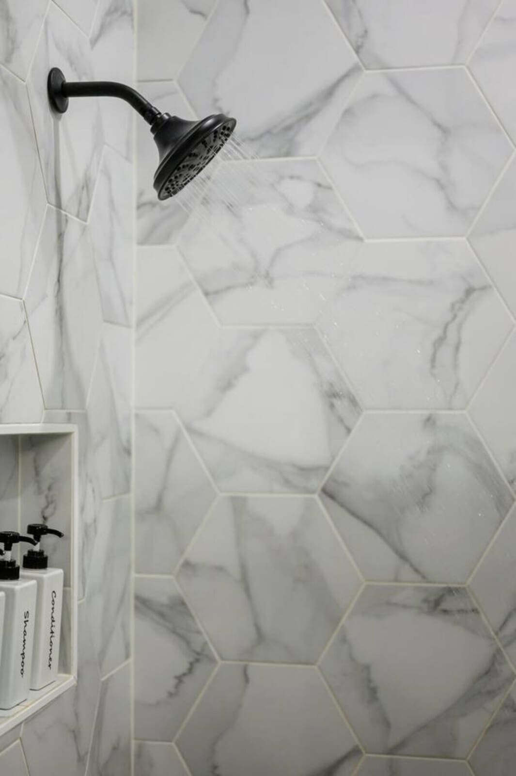 Rainfall showerhead and marble hex tile make this bathroom feel like a spa retreat.