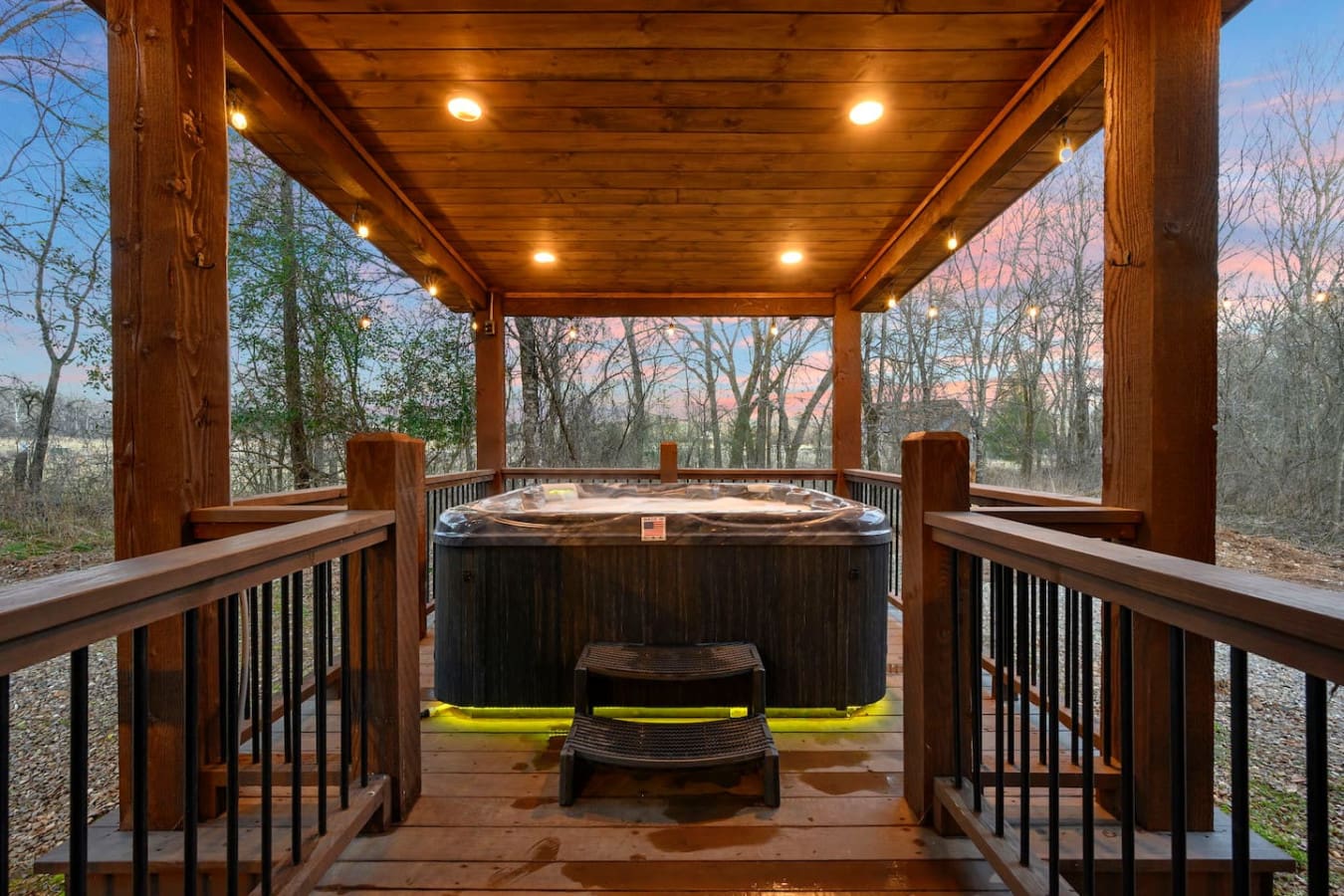 Soak under the stars in this covered hot tub pavilion with panoramic forest views and ambient lighting.