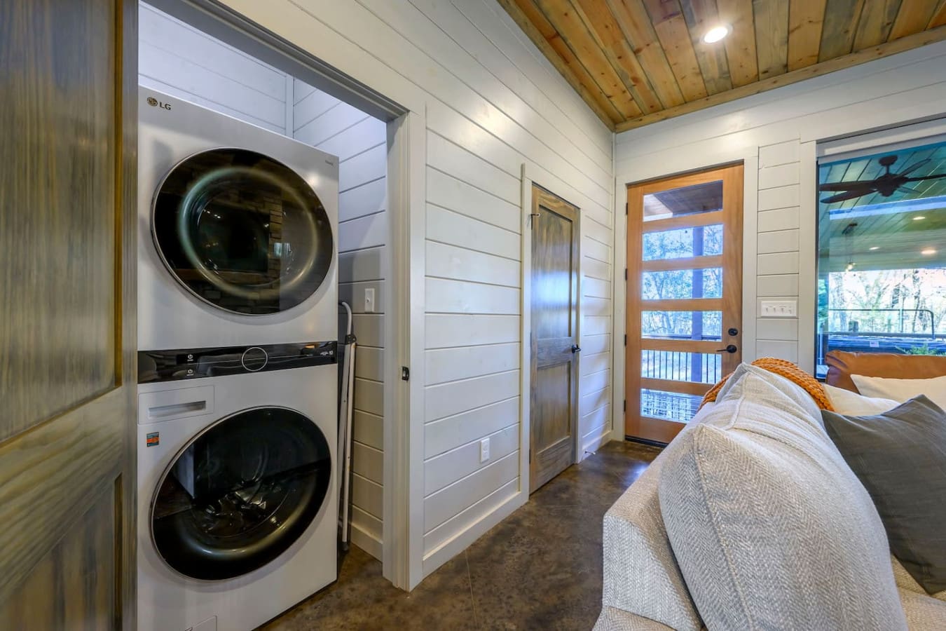 This gorgeous bedroom suite even has its own laundry room with a high-end LG washer and dryer combo.