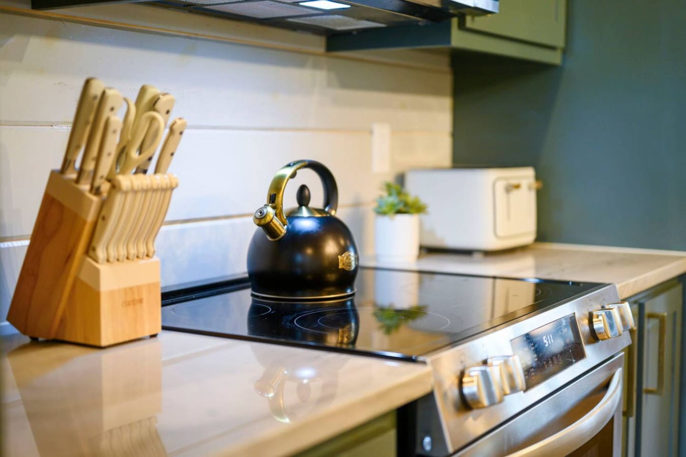 Modern kitchen with sleek induction cooktop and stainless steel appliances perfect for preparing meals.