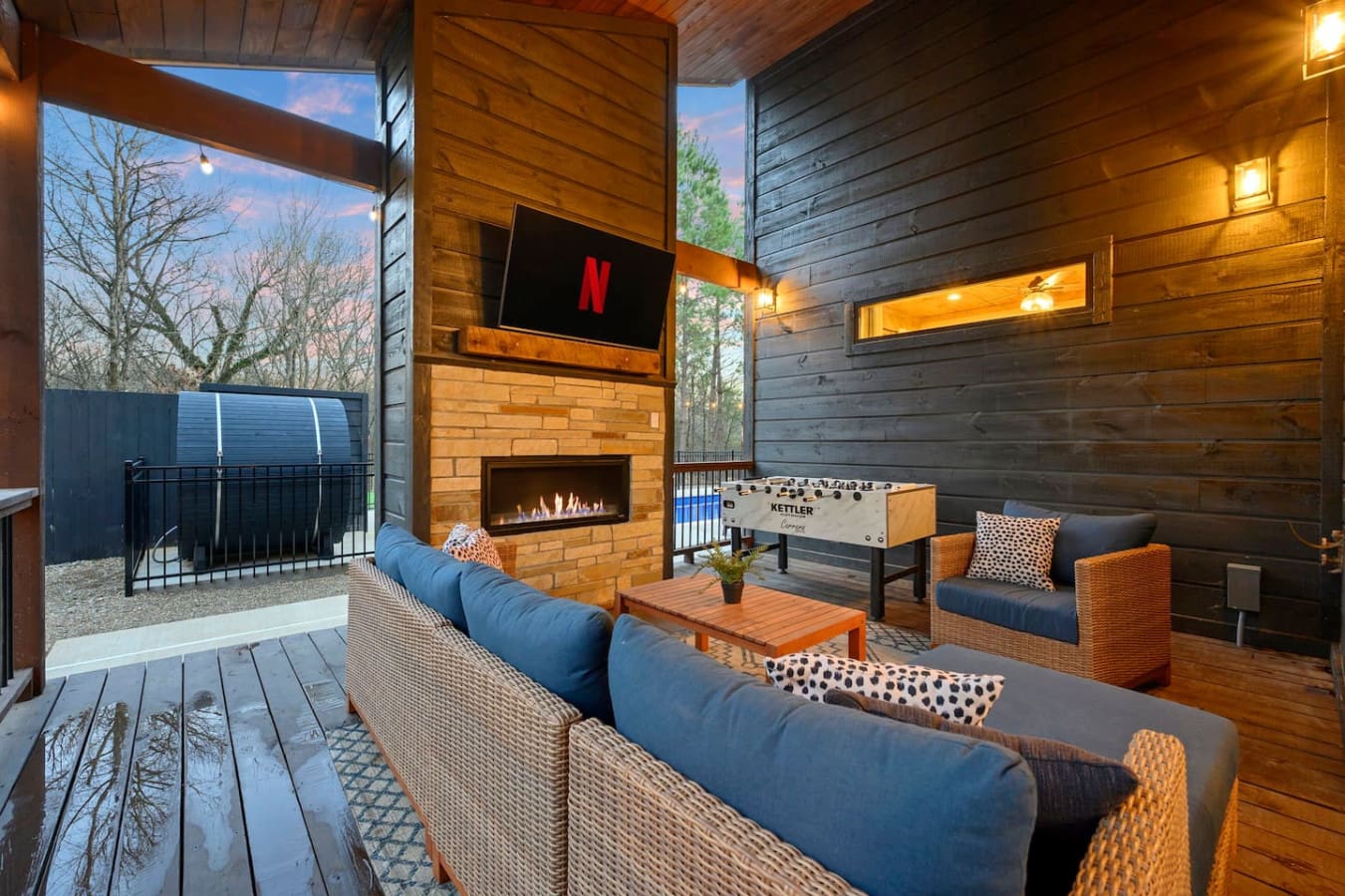This covered outdoor lounge has everything you'd want for year-round entertaining—fireplace, TV, foosball, and views for days.