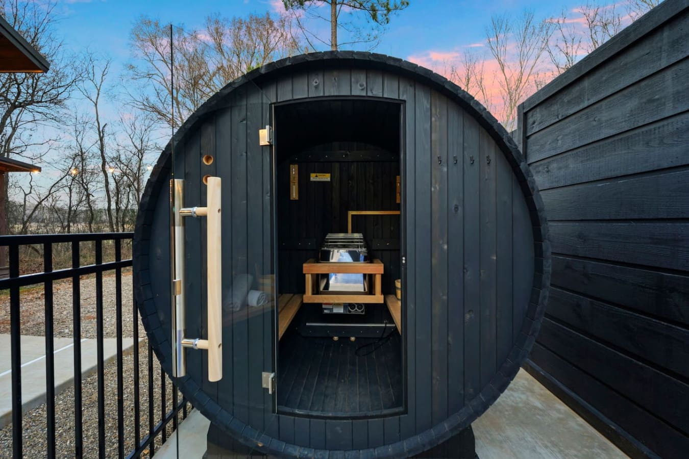 Step inside this ultra-modern barrel sauna with panoramic forest views—a seriously cool spot to unwind.