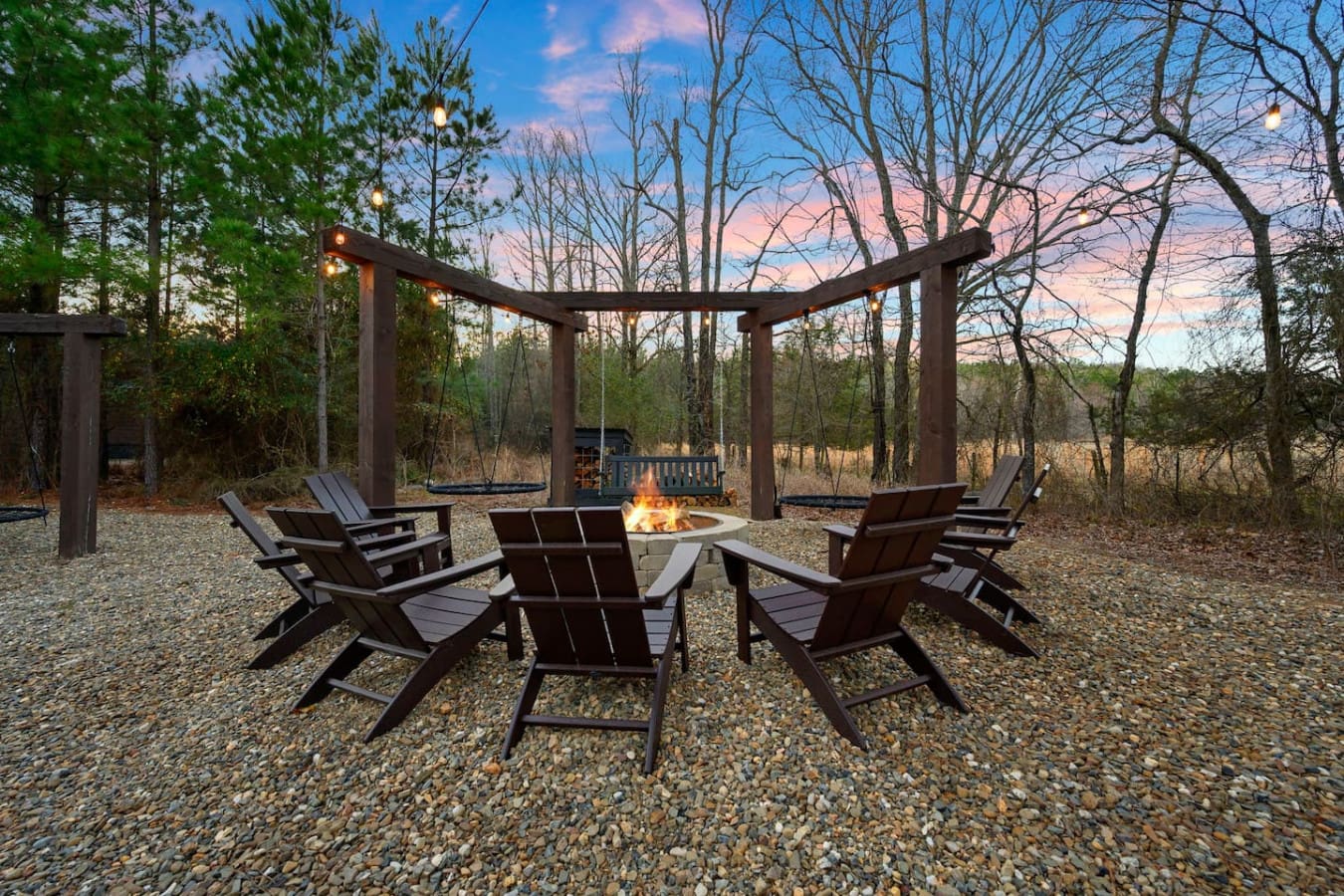 Gather around the fire pit under the pergola and take in those gorgeous sunset views over the trees.