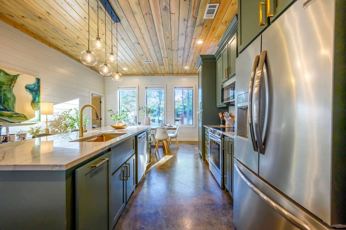 This chef's kitchen features stainless steel appliances, custom cabinetry, and tons of natural light from those gorgeous windows.