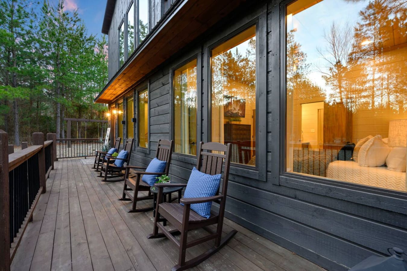 Imagine sipping your morning coffee from one of these rocking chairs while gazing out at the peaceful forest.