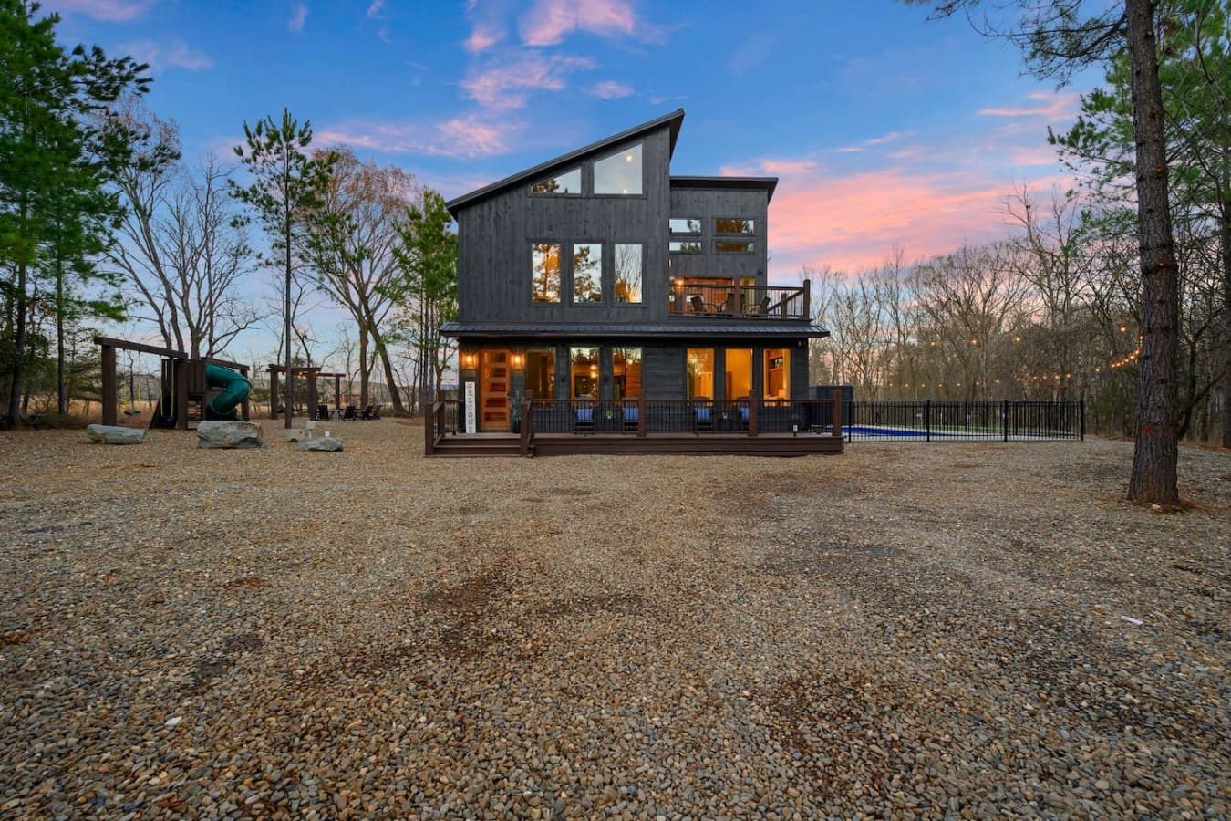 Modern riverside cabin with floor-to-ceiling windows, spacious deck, and plenty of room to spread out on the grounds.