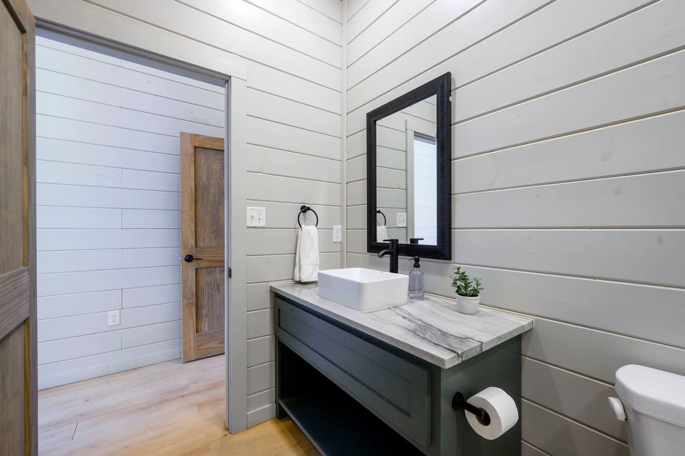 This spa-like primary bathroom features sleek finishes, a floating vanity, and direct access to the walk-in shower.