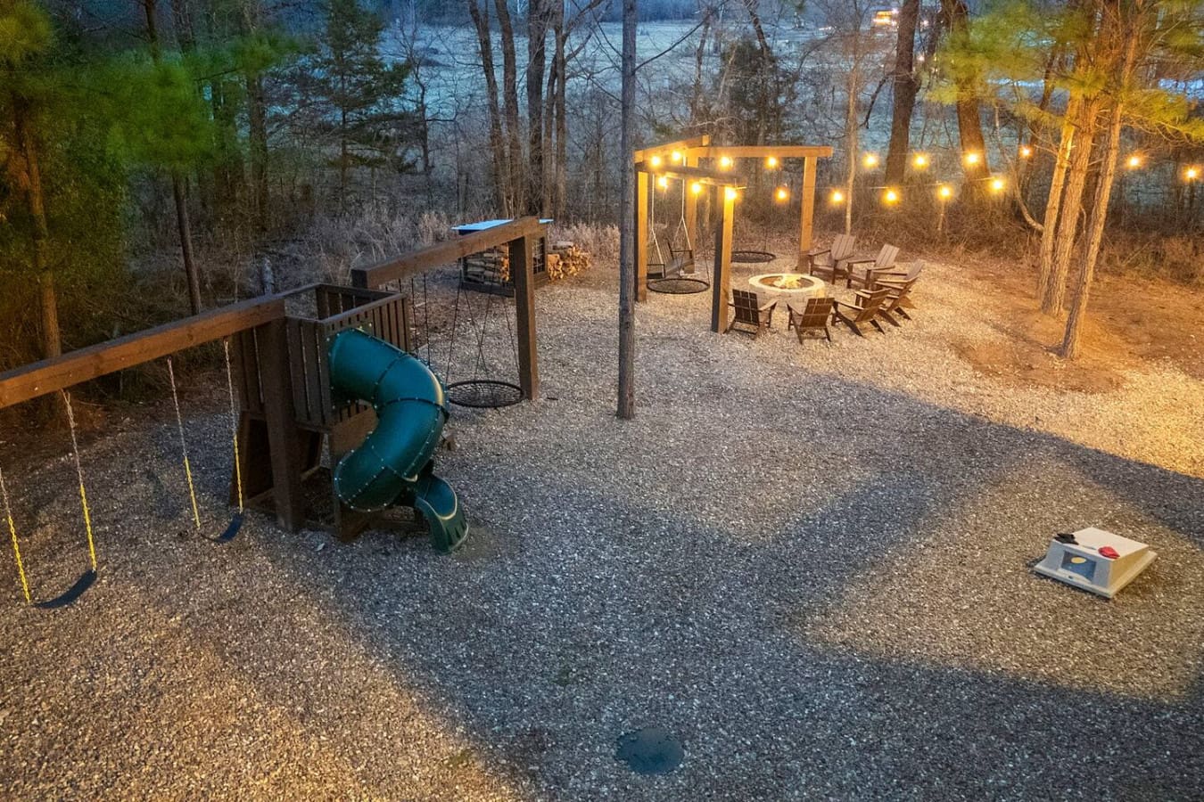 This backyard setup is perfect for evening hangouts with the fire pit, string lights, and plenty of space to roam.