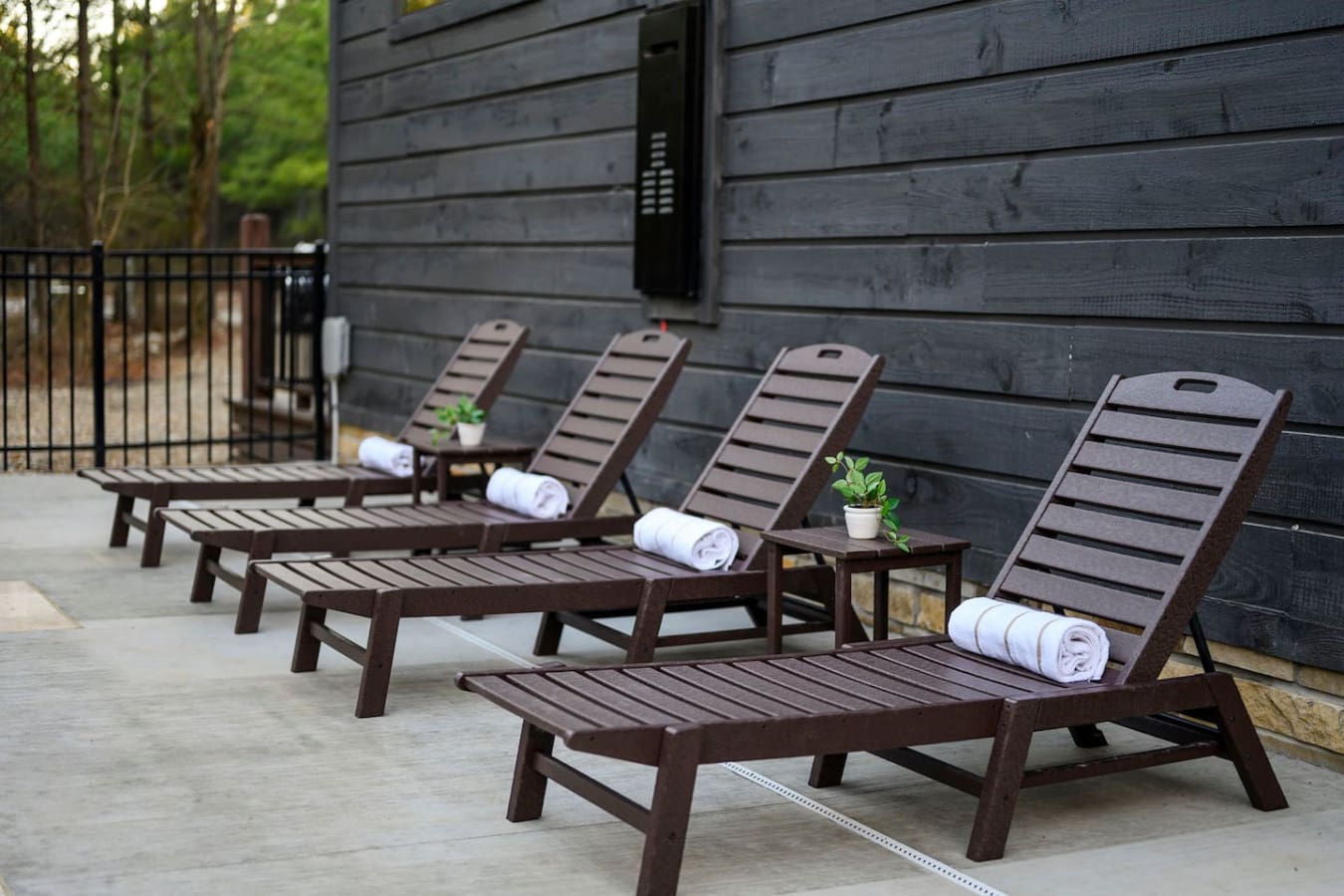 The patio features a lineup of private loungers perfect for soaking up the sun and forest views.