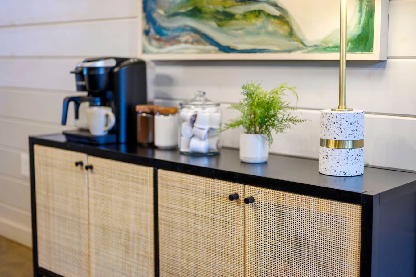 Modern sideboard with rattan doors and brass accents adds that perfect mid-century touch to the room.