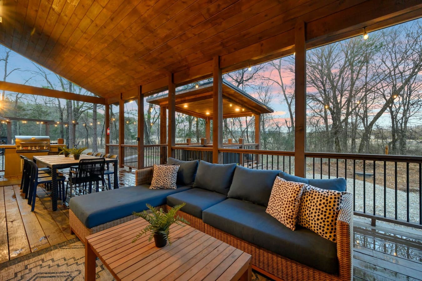 Massive screened porch with comfy seating, dining, and unbeatable views of the woods at sunset.