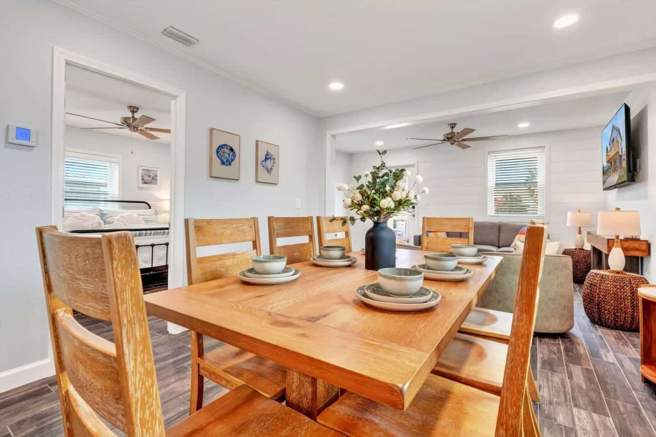 This open-concept dining and living area features beautiful wood furnishings and flows seamlessly into a cozy bedroom retreat.