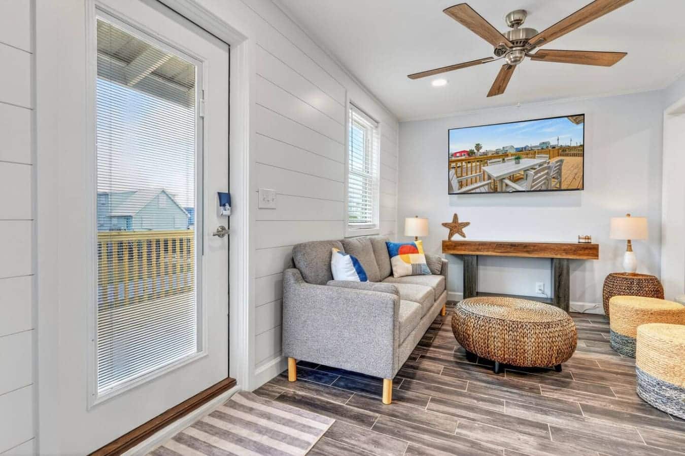 This bright sunroom has everything you need to chill out with a view, complete with comfy seating and direct deck access.