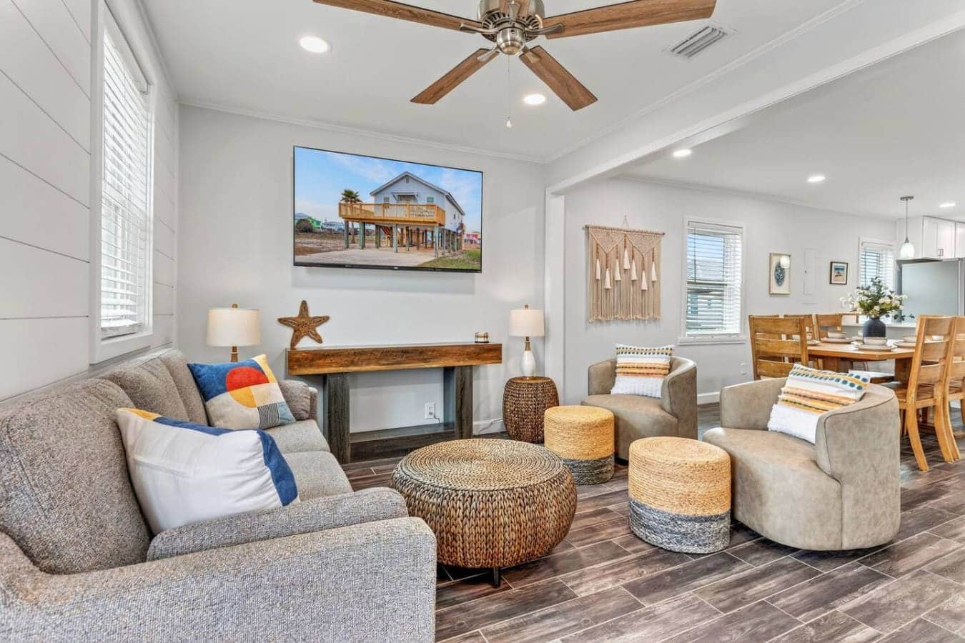 This bright, open-concept living area features comfortable seating, a fireplace, and flows seamlessly into the dining space.