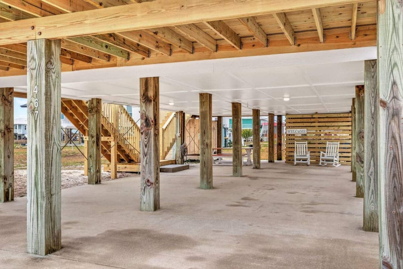 Covered pavilion with exposed beams and weathered wood posts, perfect for gatherings right on the sand.