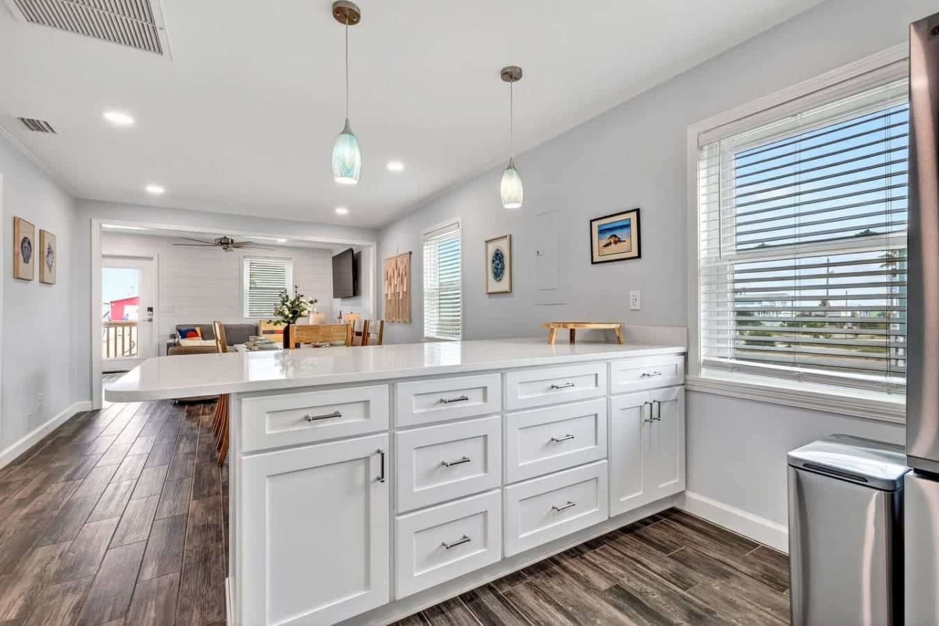 This bright, modern kitchen flows seamlessly into the living area with stunning views and plenty of space to gather.