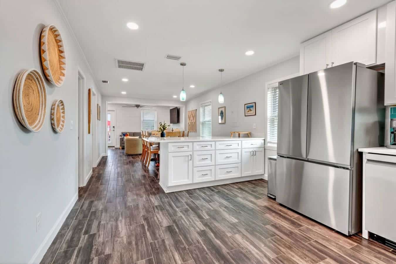 This modern kitchen flows seamlessly into the living area with stainless steel appliances and plenty of storage.